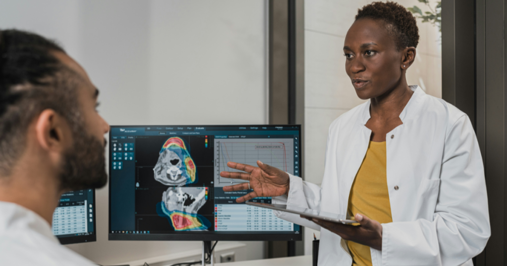 Healthcare experts analyzing patient scans on a computer screen, using artificial intelligence search tools for advanced medical data optimization.